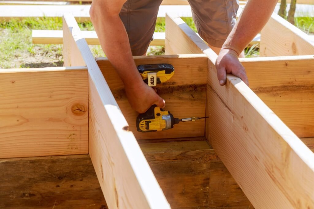 tilbygning - Munch og Madsen - full length of carpenter drilling wood at construc 2022 08 01 04 00 25 utc - Tilbygning